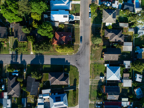 Aerial view of Singleton streets and homes in town on sunlit morning in summer