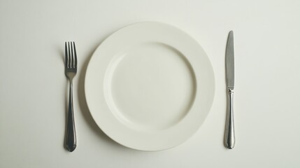 Empty white plate and utensils on white background for restaurant or menu photography