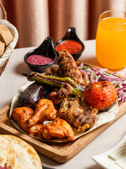 Kebab assortment in wooden plate. Lamb kebab, lula kebab, chicken kebab and vegetables kebab