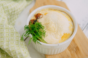 Indulge in a delectable baked dish topped with fresh dill and cheese, captured in a relaxing...