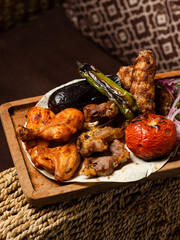 Kebab assortment in wooden plate. Lamb kebab, lula kebab, chicken kebab and vegetables kebab