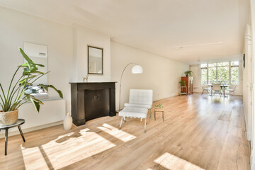 Bright and airy interior space featuring minimalist design elements, large windows, and wooden flooring, creating a serene and contemporary atmosphere.