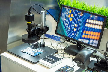 Computer board under electron microscope. Equipment for testing microboards. Enlarged motherboard...