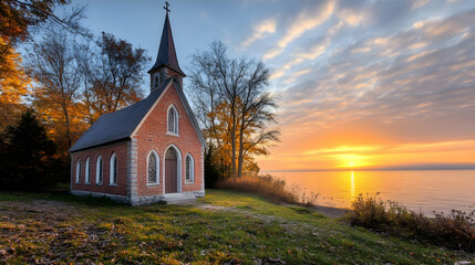 Fototapeta premium Sunrise over lake, autumnal brick chapel. Peaceful landscape, travel, postcard