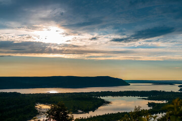 A beautiful sunset over a lake with mountains in the background