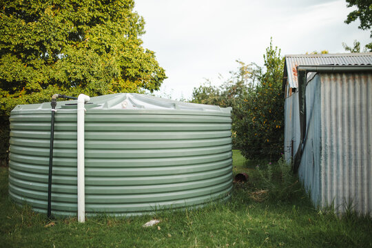 Rain water tank beside shed on rural farm property