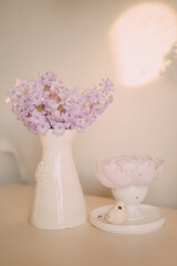 Pastel Spring Flowers in Elegant Ceramic Vase on Light Background