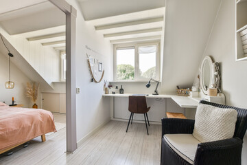 A serene and modern bedroom featuring a comfortable bed, a stylish workspace, and a cozy reading chair, blending aesthetics with functionality seamlessly.