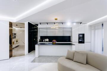 A cozy living room with a comfy couch and kitchen behind