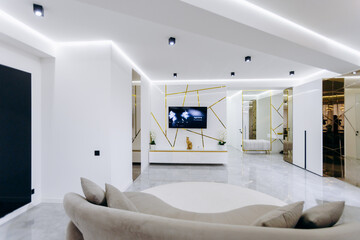 A living room with a round couch and a flatscreen TV