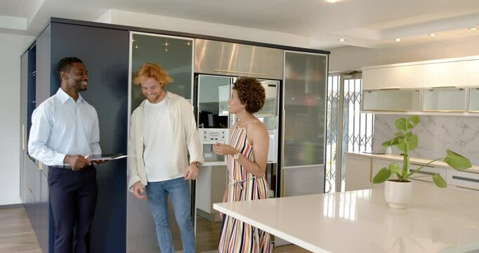 Happy and couple and male estate agent doing a house tour, talking and signing a contract