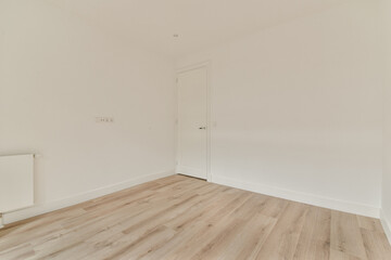A simple and clean interior space featuring light-colored walls and wooden flooring. The room has a modern, uncluttered look, ideal for minimalistic decor.