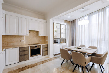 A kitchen and dining room featuring a table and chairs
