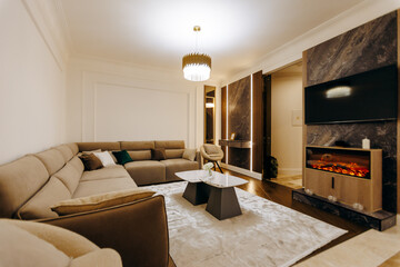 A living room with a couch, coffee table, fireplace, and TV