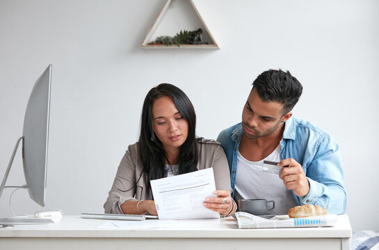 Young couple paying credit card debt online