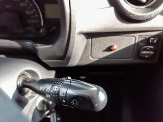 turn signal lever on the steering wheel of a car