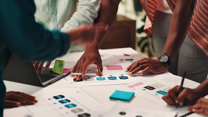 Fototapeta premium People, hands and planning with documents for design, strategy or brainstorming on office desk. Group, employees or creative designers working together with paperwork, notes or ideas at workplace
