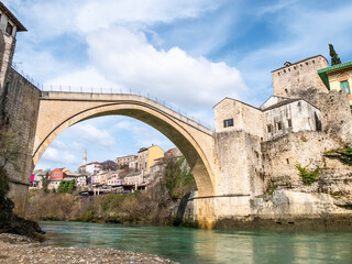 The Old Bridge (Stari Most) seen from the river banks on a sunny afternoon in Mostar, Bosnia and Herzegovina