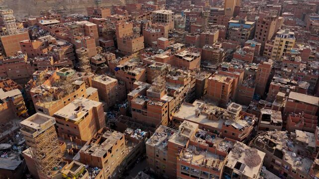 Aerial View Of Garbage City (Manshiyat Naser) in Cairo, Egypt - Brick Buildings With Rooftops Filled With Recyclables.
