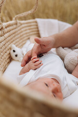 ! the month-old son holds his father's finger tightly with his hand
