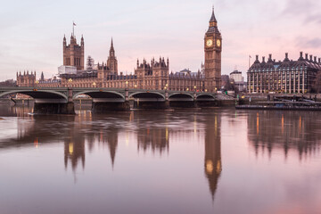 Houses of Parliament, Big Ben and Westminster bridge reflected in the River Thames at sunrise, London, England, UK