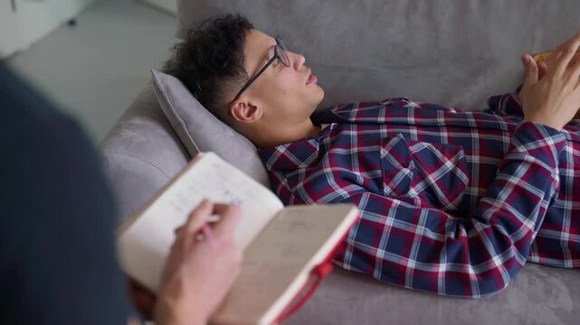 anxious young man in therapy session with psychologist, mental health support, psychological counseling, psychiatry or life coaching in cozy interior