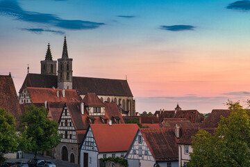 Fototapeta premium View over the rooftops of Rothenburg ob der Tauber to St. James's Church in the background at sunset