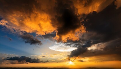 Black orange yellow sky with clouds. Dramatic golden color sunset. Sunlight. A storm is coming. Background with space for design.