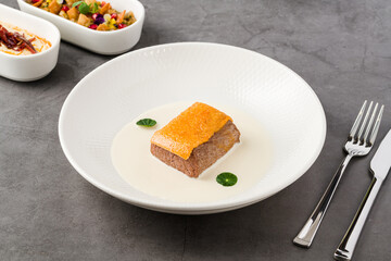 Gourmet beef served with creamy white sauce and crispy topping