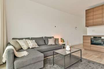 A stylish modern living room featuring a sleek sofa, elegant coffee table, and contemporary...