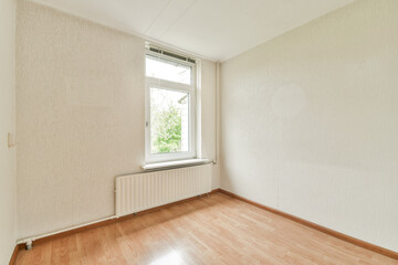 Empty minimalist interior featuring a single window that allows natural light to illuminate the space, highlighting the clean lines and simple design.