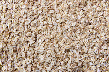 Uncooked oat flakes for healthy breakfast on the table.