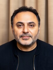 Obraz premium A middle aged man with a thoughtful expression looks forward