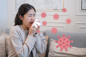 Woman sneezing suffering from allergy viral infection common cold flu COVID-19 pandemic