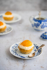 Lemon cupcakes with cream cheese, apricot and poppy seed. Cupcake in form of Fried Egg on a stone background. Easter eggs. Easter holiday and festive food.