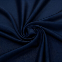 Obraz premium Elegant fabric swirl: The close-up shot displays a luxurious, intricately textured, dark blue fabric, its folds and curves artfully arranged to create a mesmerizing display of depth and movement.
