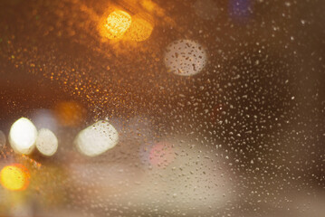 Blurred background with raindrops and lights.