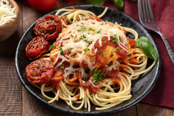 Chicken parmesan with spaghetti noodles, sauce and roasted tomatoes