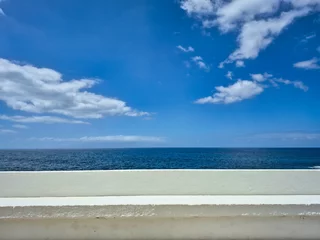 Photo sur Plexiglas Scenic view of the atlantic ocean from a white wall in tenerife, canary islands, spain, featuring a beautiful blue sky with some clouds
