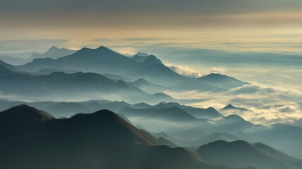 Obraz premium Aerial view of the foggy mountains at sunrise. The panorama of cascading mountains and a sea of clouds in the Chinese art style is reminiscent of National Park Award winning photographs.