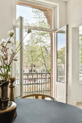 A refined interior scene showcasing open windows that invite natural light, with a decorative...