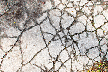 Close-up of cracked asphalt texture. Cracked asphalt texture in