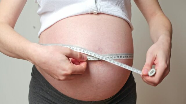 belly size during pregnancy, a woman measures her belly circumference in the ninth month of pregnancy