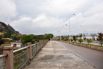Chinese people and travelers thai people travel walking on footpath beside Nanbin road go to visit Tiantan temple in Tian Tan Garden at Shantou town or Swatow city in Chaozhou, China
