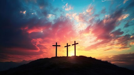 Obraz premium Silhouettes of three crosses at sunset.