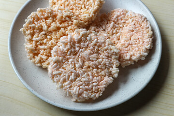 Rice crackers or Rengginang on a white plate, a typical Indonesian snack