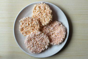 Rice crackers or Rengginang on a white plate, a typical Indonesian snack