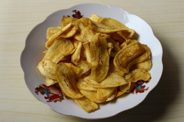Keripik pisang or Banana chips on a white plate