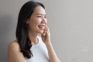 close up beautiful asian woman smile and beauty teeth and happy feeling on gray color background for veneer and invisalign treatment concept