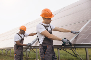 Two Engineers Installing Solar Panels on a Clear Day